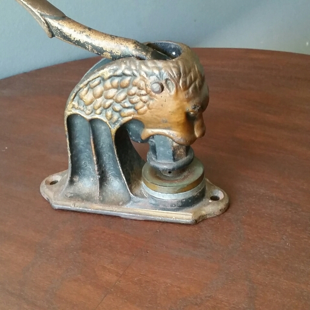 Lot - Antique hand crank food chopper and cast iron figural lion embossed  seal press.