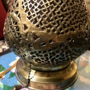 close up pierced brass lamp