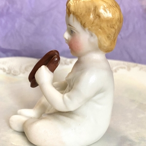 Figurine of a porcelain boy eating - left side rotation