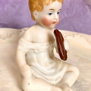 Figurine of a porcelain boy eating - right side